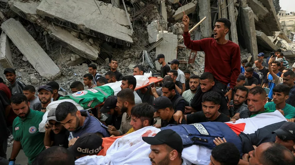 A flak jacket and a Palestinian flag are placed on the body of Al Jazeera journalist Anas Al Sharif, during the funeral for him, Mohammed Qreiqeh, Ibrahim Zaher, Mohammed Noufal and another colleague, who were killed in an Israeli strike, in Gaza City August 11, 2025. REUTERS/Dawoud Abu Alkas   TPX IMAGES OF THE DAY