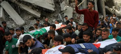 A flak jacket and a Palestinian flag are placed on the body of Al Jazeera journalist Anas Al Sharif, during the funeral for him, Mohammed Qreiqeh, Ibrahim Zaher, Mohammed Noufal and another colleague, who were killed in an Israeli strike, in Gaza City August 11, 2025. REUTERS/Dawoud Abu Alkas   TPX IMAGES OF THE DAY