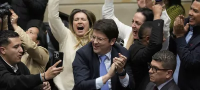 FILE - Miguel Uribe Turbay, center in blue tie, a Colombian senator and presidential candidate for the right-wing Centro Democrático party, celebrates after voting against a labor reform referendum proposed by the government, in Bogota, Colombia, May 14, 2025. (AP Photo/Fernando Vergara, File)