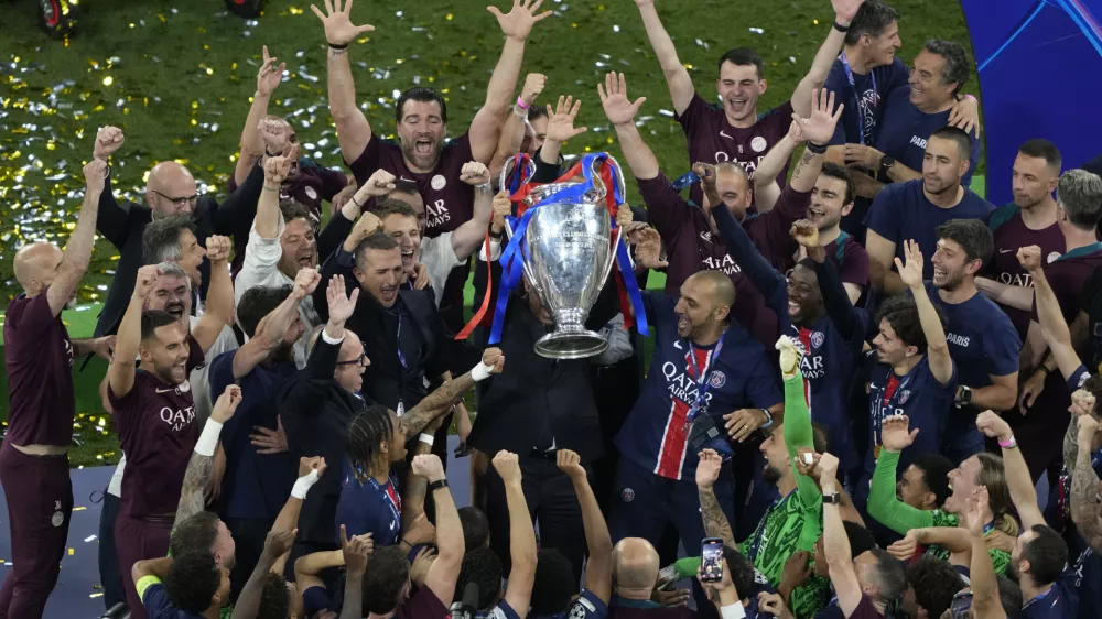 Players of PSG lift the trophy after winning the Champions League tournament at the Allianz Arena in Munich, Germany, Saturday, May 31, 2025. (AP Photo/Michael Probst)