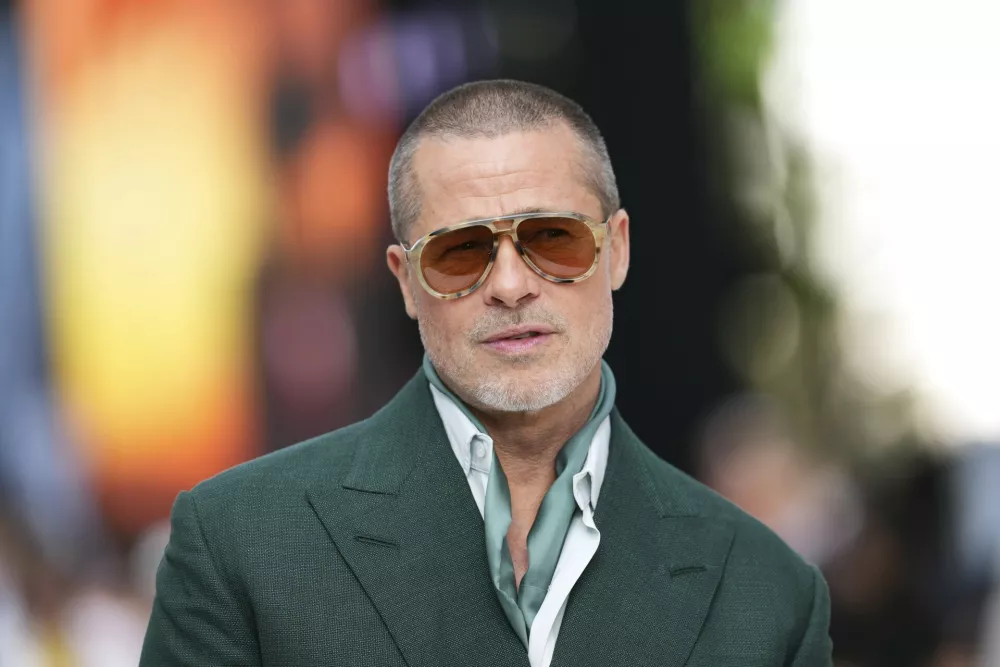 FILE - Brad Pitt poses for photographers upon arrival at the premiere of the film 'F1 The Movie' on Monday, June 23, 2025, in London. (Photo by Scott A Garfitt/Invision/AP, file)