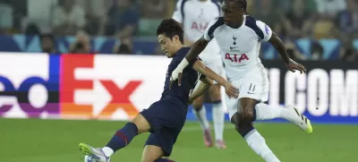 PSG's Kang-in Lee, left, and Tottenham's Mathys Tel challenge for the ball during the UEFA Super Cup soccer match between Paris Saint-Germain and Tottenham Hotspur in Udine, Italy, Wednesday, Aug. 13, 2025. (AP Photo/Antonio Calanni)