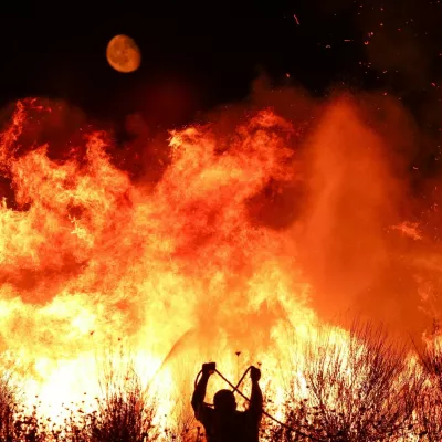 A firefighter works as wildfire continues to burn in Delvina, Albania, August 12, 2025. REUTERS/Florion Goga