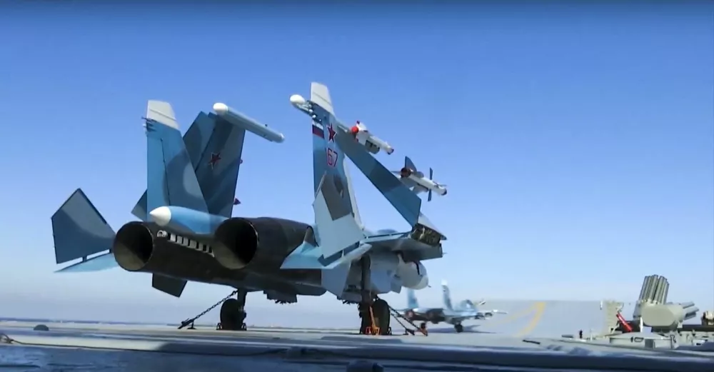 In this photo made from the footage taken from Russian Defense Ministry official web site on Tuesday, Nov. 15, 2016, Russian Su-33 fighter jets are parked on the flight deck of the Admiral Kuznetsov aircraft carrier in the eastern Mediterranean Sea. The Russian military on Tuesday launched a series of strikes on militant targets in Syria involving carrier-borne fighters, marking the Admiral Kuznetsov's combat debut. (Russian Defense Ministry Press Service/ Photo via AP)