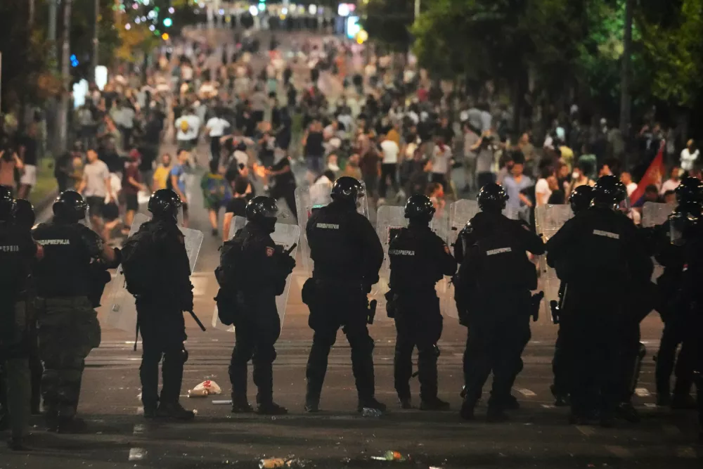 Serbian gendarmerie officers guard the street during an anti-government protest near Serbian Progressive Party office in Belgrade, Serbia, Thursday, Aug. 14, 2025. (AP Photo/Darko Vojinovic)