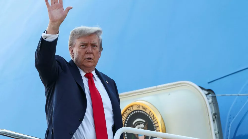 U.S. President Donald Trump waves while boarding Air Force One, as he departs for Alaska to meet with Russian President Vladimir Putin to negotiate for an end to the war in Ukraine, from Joint Base Andrews in Maryland, U.S., August 15, 2025. REUTERS/Kevin Lamarque