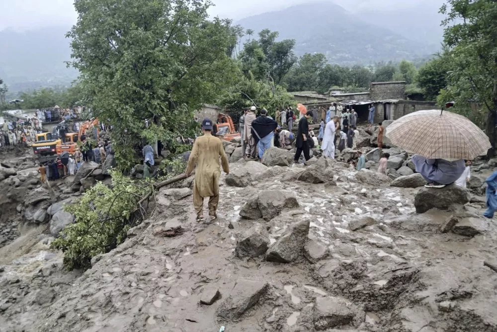 Rescuers and local residents participate in a rescue operation at the site of a massive cloudburst that led to flash flooding in Salarzai, in Bajaur district, in northwestern Pakistan, Friday, Aug. 15, 2025. (AP Photo/Qyass Khan)