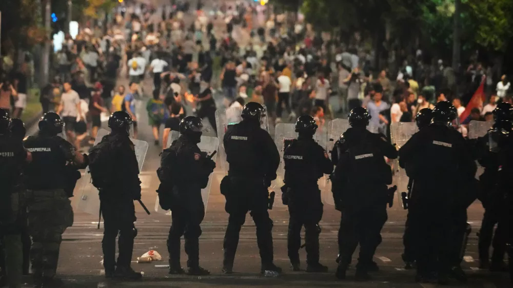 Serbian gendarmerie officers guard the street during an anti-government protest near Serbian Progressive Party office in Belgrade, Serbia, Thursday, Aug. 14, 2025. (AP Photo/Darko Vojinovic)
