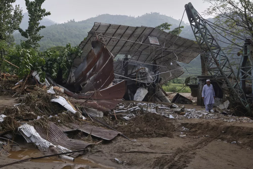 A local resident walks through a structure damaged after Friday's flash flooding on the outskirts of Pir Baba, Buner district, in Pakistan's northwest, Saturday, Aug. 16, 2025. (AP Photo/Muhammad Sajjad)
