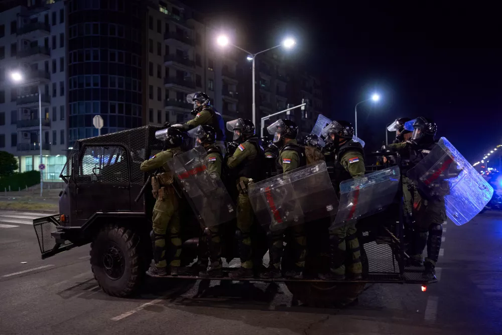 16 August 2025, Serbia, Belgrade: Police officers stand on an armored crowd-control vehicle. Demonstrators clashed with riot police in Belgrade as tear gas was used during days of anti-government protests. Photo: Marko Dimic/ZUMA Press Wire/dpa