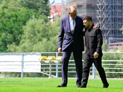 Ukrainian President Volodymyr Zelensky (R) is welcomed by German Chancellor Friedrich Merz upon arrival in the garden of the chancellery in Berlin to join a video conference of European leaders with the US President on the Ukraine war ahead of the summit between the US and Russian leaders, on August 13, 2025. European leaders will hold online talks with US President Donald Trump, hoping to convince him to respect Ukraine's interests when he discusses the war with Putin in Alaska on Friday.   JOHN MACDOUGALL/Pool via REUTERS