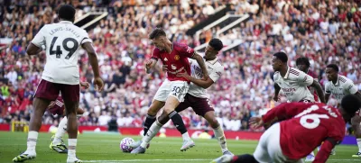 Arsenal's William Saliba, ceter right, challenges Manchester United's Benjamin Sesko during the English Premier League soccer match between Manchester United and Arsenal at Old Trafford stadium in Manchester, England, Sunday, Aug. 17, 2025. (AP Photo/Dave Thompson)