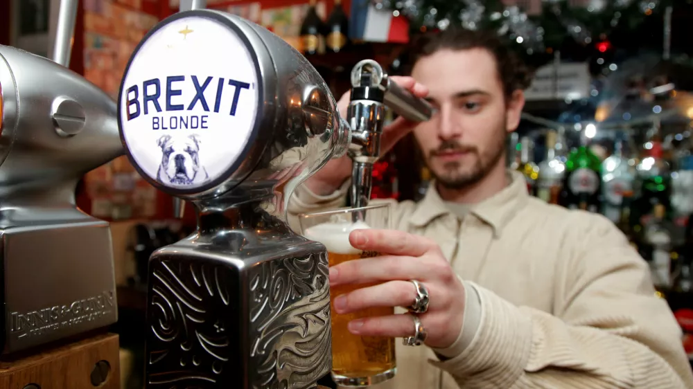 FILE PHOTO: Thibault, barman at the Cricketer English Pub, serves a Brexit draft beer in Paris, France, December 17, 2018. REUTERS/Charles Platiau/File Photo
