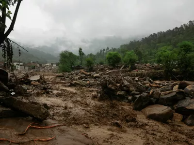Rain water flowing from mountains crosses a damaged area, following a storm that caused heavy rains and flooding in Bayshonai Kalay, in Buner district, in Khyber Pakhtunkhwa province, Pakistan, August 18, 2025. REUTERS/Akhtar Soomro