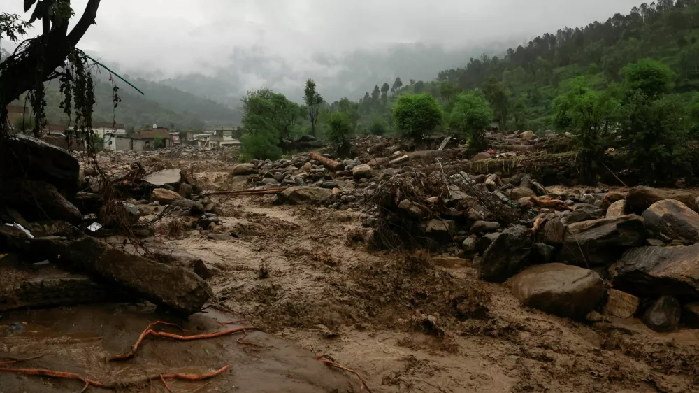 Rain water flowing from mountains crosses a damaged area, following a storm that caused heavy rains and flooding in Bayshonai Kalay, in Buner district, in Khyber Pakhtunkhwa province, Pakistan, August 18, 2025. REUTERS/Akhtar Soomro