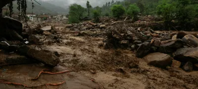 Rain water flowing from mountains crosses a damaged area, following a storm that caused heavy rains and flooding in Bayshonai Kalay, in Buner district, in Khyber Pakhtunkhwa province, Pakistan, August 18, 2025. REUTERS/Akhtar Soomro