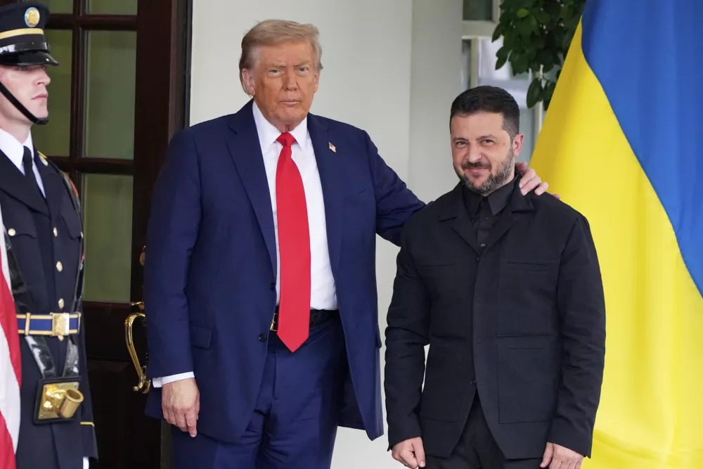 President Donald Trump, left, greets Ukraine's President Volodymyr Zelenskyy as he arrives at the White House, Monday, Aug. 18, 2025, in Washington. (AP Photo/Alex Brandon)