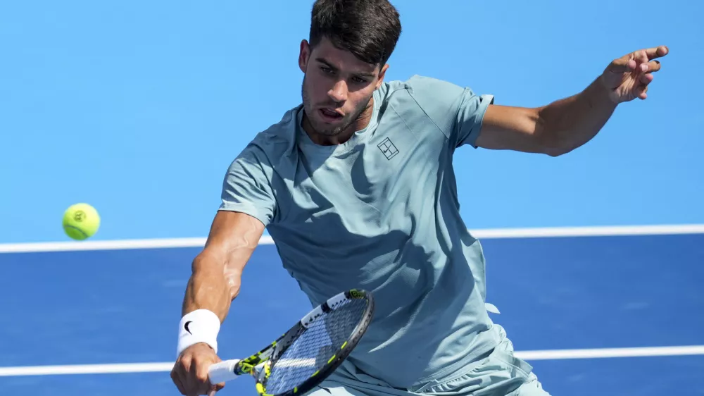 Aug 10, 2025; Cincinnati, OH, USA; Carlos Alcaraz (ESP) returns a shot against Damir Dzumhur (BIH) during the Cincinnati Open at the Lindner Family Tennis Center. Mandatory Credit: Aaron Doster-Imagn Images