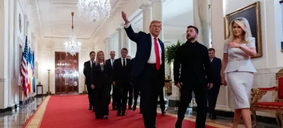 President Donald Trump, center, walks in the Cross Hall with Ukrainian President Volodymyr Zelenskyy, followed by British Prime Minister Keir Starmer, French President Emmanuel Macron, German Chancellor Friedrich Merz, Italian Prime Minister Giorgia Meloni, Finnish President Alexander Stubb, NATO Secretary General Mark Rutte and European Commission President Ursula von der Leyen, at the White House, Monday, Aug. 18, 2025, in Washington. (AP Photo/Alex Brandon)