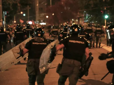 Serbian gendarmerie officers chase protesters during an anti-government protest in Belgrade, Serbia, Monday, Aug. 18, 2025. (AP Photo/Darko Vojinovic)
