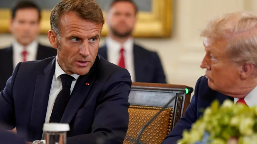 French President Emmanuel Macron speaks to U.S. President Donald Trump during a meeting with Ukrainian President Volodymyr Zelenskiy (not pictured) and European leaders amid negotiations to end the Russian war in Ukraine, at the White House in Washington, D.C., U.S., August 18, 2025. REUTERS/Al Drago
