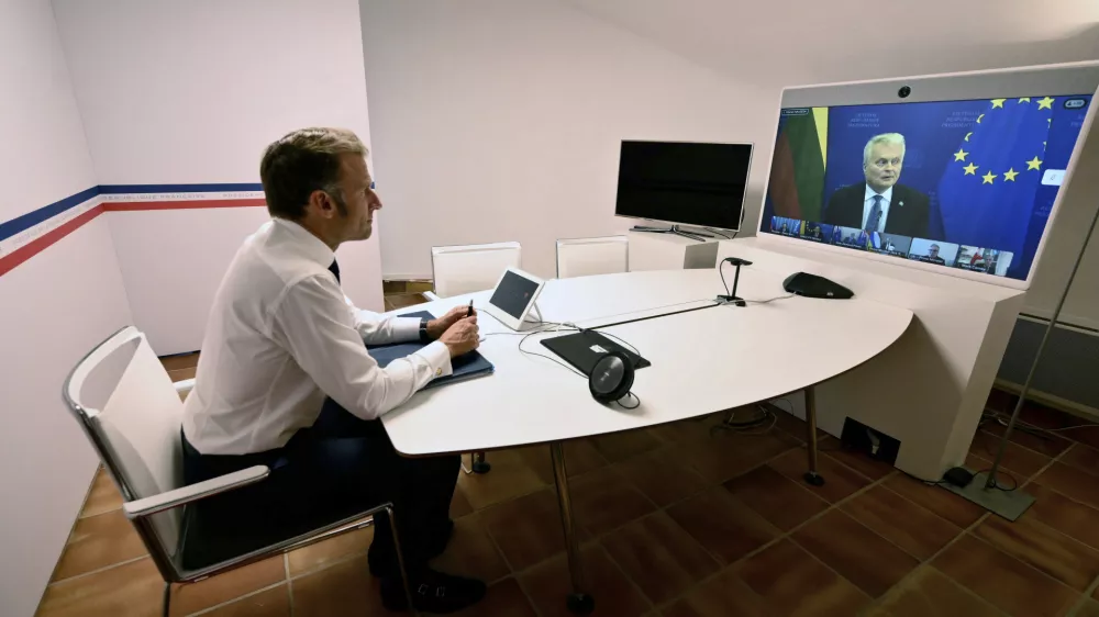 French President Emmanuel Macron listens to Lithuania's President Gitanas Nauseda as he takes part in a video meeting of the so-called "coalition of the willing" to discuss next steps for Ukraine, Monday Aug.19, 2025 at the Fort de Bregancon in Bormes-les-Mimosas, southern France. (Christophe Simon, Pool via AP)