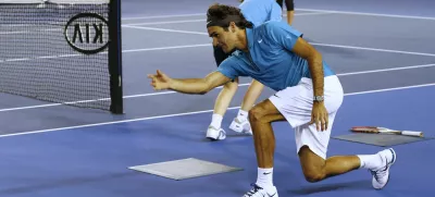 Switzerland's Roger Federer throws the ball along the court as he acts as a ball boy during an exhibition match during the Kids Tennis Day at Melbourne Park ahead of the Australian Open tennis championship in Melbourne, Australia, Saturday, Jan. 12, 2013. (AP Photo/Andy Wong)