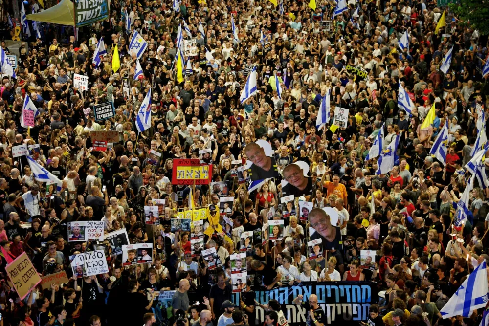 FILE PHOTO: Demonstrators attend a protest demanding the immediate release of the hostages kidnapped during the deadly October 7, 2023 attack on Israel by Hamas, and the end of the war, in Tel Aviv, Israel, August 9, 2025. REUTERS/Amir Cohen/File Photo