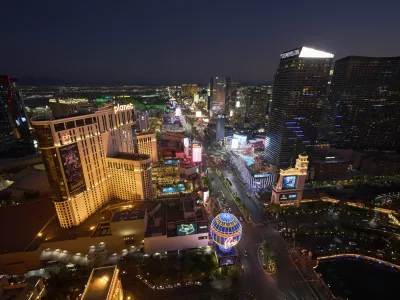 Cars drive along the Las Vegas Strip, Saturday, Aug. 2, 2025, in Las Vegas. (AP Photo/John Locher)
