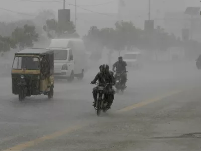 Commuters travel on a road during heavy rain in Karachi, Pakistan, August 20, 2025. REUTERS/Shakil Adil