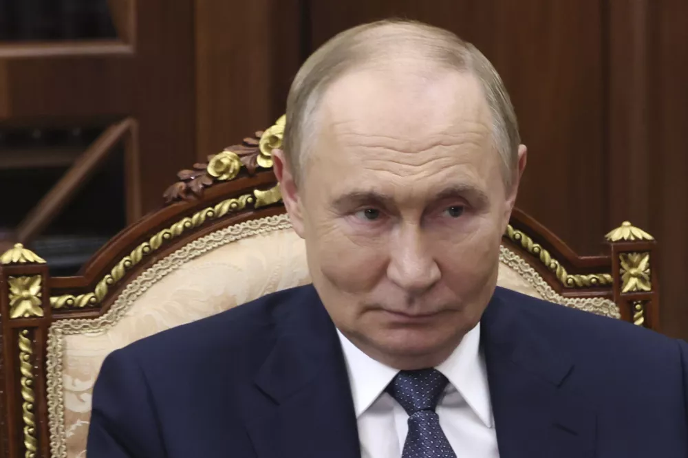 Russian President Vladimir Putin listens to Acting Governor of the Russia's Far East Jewish Autonomous Area Maria Kostyuk during their meeting at the Kremlin in Moscow, Russia, Wednesday, Aug. 20, 2025. (Vyacheslav Prokofyev, Sputnik, Kremlin Pool Photo via AP)