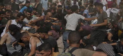 Palestinians struggle to collect humanitarian aid airdropped into Gaza City, northern Gaza Strip, Thursday, Aug. 14, 2025. (AP Photo/Jehad Alshrafi)