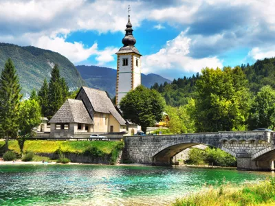 Bohinj Lake, Church of St John the Baptist with bridge. Triglav National Park, Julian Alps, Slovenia.