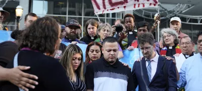 Jennifer Vasquez Sura, front left, her husband Kilmar Abrego Garcia, front center, and Attorney Simon Sandoval-Moshenberg, front right, attend a protest rally at the Immigration and Customs Enforcement field office in Baltimore, Monday, Aug. 25, 2025, to support Kilmar Abrego Garcia. (AP Photo/Stephanie Scarbrough)