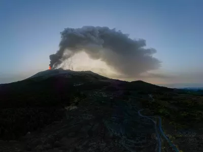 A drone view shows smoke rising from a crater of Mount Etna at dawn, Europe's most active volcano, Italy July 7, 2024. REUTERS/Etna Walk/Giuseppe Di Stefano