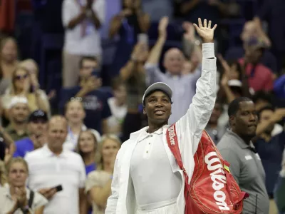 Venus Williams, of the United States, waves to fans after being defeated by Karolina Muchova, of the Czech Republic, during the first round of the U.S. Open tennis championships, Monday, Aug. 25, 2025, in New York. (AP Photo/Adam Hunger)