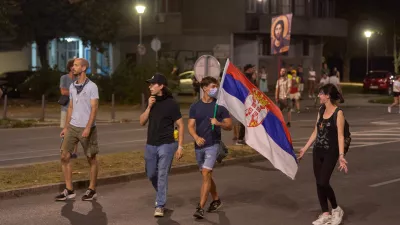 16 August 2025, Serbia, BelgradeProtesters carry a Serbian flag in the street. during an anti-government protest in Belgrade. Demonstrators clashed with riot police in Belgrade as tear gas was used during days of anti-government protests. PhotoMarko Dimic/ZUMA Press Wire/dpa