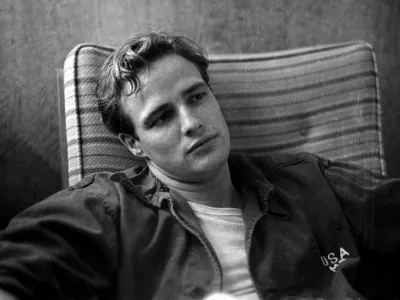 Marlon Brando, sitting on the porch, during the filming of"The Men".