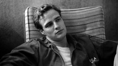 Marlon Brando, sitting on the porch, during the filming of"The Men".