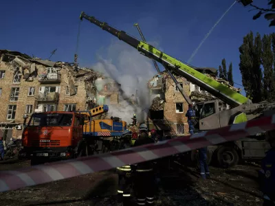 Rescue workers clear the rubble of a residential house destroyed by a Russian strike in Kyiv, Ukraine, on Thursday, Aug. 28, 2025. (AP Photo/Evgeniy Maloletka)