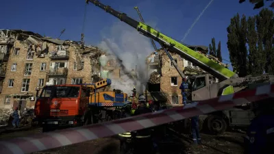 Rescue workers clear the rubble of a residential house destroyed by a Russian strike in Kyiv, Ukraine, on Thursday, Aug. 28, 2025. (AP Photo/Evgeniy Maloletka)