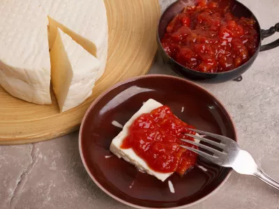 Brazilian dessert Romeo and Juliet, goiabada jam of guava and cheese Minas on marble table. Selective focus