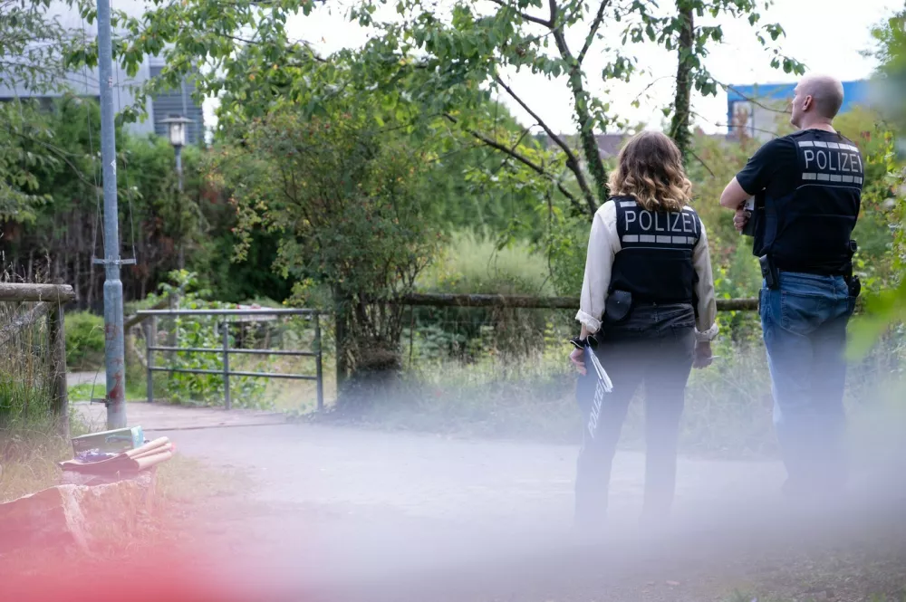 29 August 2025, Baden-W&uuml;rttemberg, Filderstadt: Two police officers stand in front of a bridge on the outskirts of Filderstadt. A suitcase with a body inside was found under a bridge by a small stream in Filderstadt. Photo: Markus Lenhardt/dpa,Image: 1032315730, License: Rights-managed, Restrictions: GERMANY OUT, Model Release: no