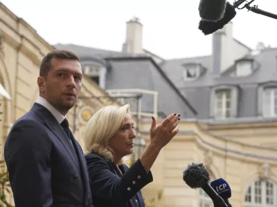 French far right leader Marine Le Pen, right, and Rassemblement National party president Jordan Bardella speak to the media following a meeting with French Prime Minister Francois Bayrou before a confidence vote, at the Hotel Matignon in Paris Tuesday, Sept. 2, 2025. (AP Photo/Thibault Camus)
