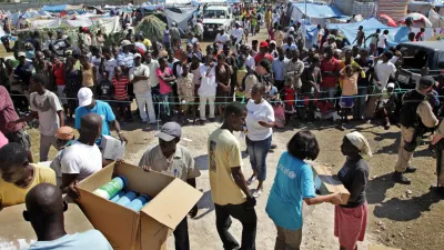 HAITI - On 24 January, Haitian aid workers and UNICEF and World Food Programme staff prepare to distribute relief supplies in the Pinchinat camp for people displaced by the earthquake, on a football pitch in the city of Jacmel. Supplies include bedding, water jugs, kitchen items and mosquito bed nets. Several UNICEF staff members wear T-shirts bearing the UNICEF logo. In a joint rapid response, UNICEF and the World Food Programme (WFP) are providing a daily hot meal for the estimated 5,000 people living in the camp. Assisted by MINUSTAH, the two agencies are also providing safe water in the camp. Some 34,000 people in Jacmel have been affected by the quake.On 24 January 2010 in Haiti, humanitarian assistance for survivors of the 7.3 magnitude earthquake that hit the country on 12 January continues to improve as capacity and logistical constraints are addressed. The quakes epicentre was only 17 kilometres from Port-au-Prince, the capital, and needs remain great. Quake aftershocks on 20 and 23 January caused further damage, especially in the town of Petit Goave. Unaccompanied children who have lost or been separated from their families are among the most vulnerable. Revised estimates by the Government report that more than 112,000 people were killed during the quake and 1.5 million have been left homeless. In Port-au-Prince, estimated numbers of people living in makeshift shelters range from 370,000800,000, despite the recent exodus of as many as 235,000 from the devastated city. Major government and private infrastructure have been destroyed or heavily damaged, including hospitals, water, sanitation and electrical systems, and telecommunications, banks and transportation networks. United Nations and UNICEF buildings and residences were also hit, and UN staff and peacekeepers with the UN Stabilization Mission in Haiti (MINUSTAH) are missing and more than 50 are confirmed to have died. MINUSTAH, totalling 7,000 peacekeepers and 2,000 police, have relocated their logistics base close to the airport to better coordinate incoming international relief assistance. The UN Consolidated Flash Appeal for the Haiti earthquake emergency requests US 5 million for relief and recovery for the next six months. UNICEFs portion of the appeal is US 7.9 million and UNICEF is the lead coordinating agency for education, child protection, nutrition and WASH (water, sanitation and hygiene). Working with the Government, other UN agencies, international and local NGOs and private partners, UNICEF is distributing safe water and equipment and health and shelter supplies, and establishing child feeding centres for children under age five. UNICEF is also working with partners to establish safe spaces for unaccompanied children and implementing procedures to identify, register and help reunite them with their families. Support has also been given to the Government to monitor children who are departing the country, to ensure that proper documentation and permissions are in place. This latest catastrophe exacerbates Haitis already critical humanitarian situation. An estimated 46 per cent of its nearly 10 million inhabitants are under age 18, and more than 78 per cent of the population lives on less than US .00 a day.