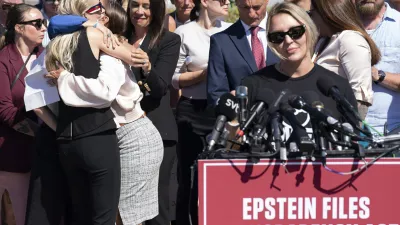 Anouska de Georgiou, left, hugs Marina Lacerda as Courtney Wild, right, speaks during a news conference at the U.S. Capitol, Wednesday, Sept. 3, 2025, in Washington. (AP Photo/Jose Luis Magana)