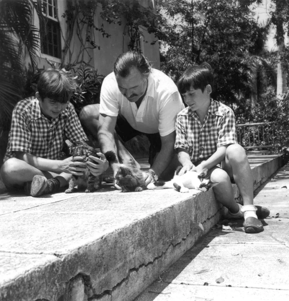 EH 2871P November 1946 Ernest Hemingway and sons Patrick (left) and Gregory, with cats Good Will, Princessa, and Boise. Finca Vigia (Hemingway home), San Francisco de Paula, Cuba. Photograph in the Ernest Hemingway Photograph Collection, John F. Kennedy Presidential Library and Museum, Boston.