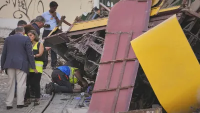 Police officers inspect the site where a tourist streetcar derailed and crashed in Lisbon, Portugal, Thursday, Sept. 4, 2025. (AP Photo/Armando Franca)
