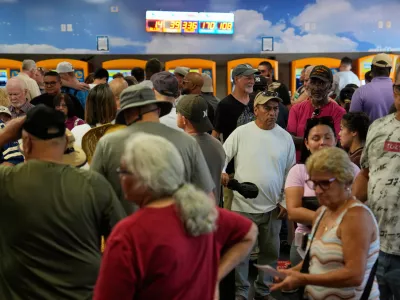 People wait in line to buy lottery tickets a the Lotto Store just inside the California border, Wednesday, Sept. 3, 2025, near Primm, Nev. (AP Photo/John Locher)