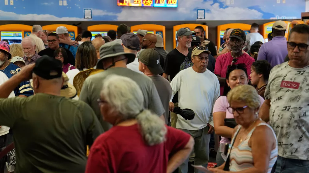 People wait in line to buy lottery tickets a the Lotto Store just inside the California border, Wednesday, Sept. 3, 2025, near Primm, Nev. (AP Photo/John Locher)